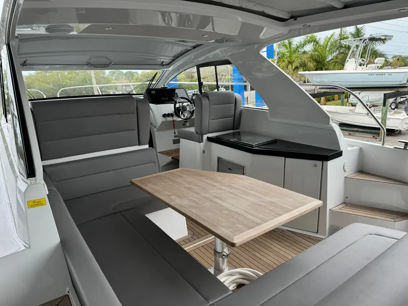 Slide: The Image of 2024 Sealine S335V yacht interior with modern seating and dining area. - 10