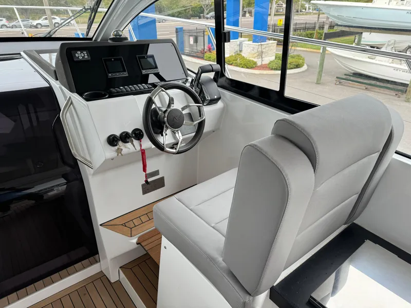 Slide: The Image of 2024 Sealine S335V boat cockpit with modern steering and controls. - 15