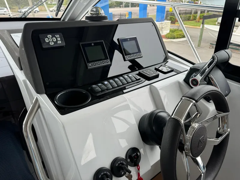 Slide: The Image of 2024 Sealine S335V boat dashboard with steering wheel and control panel. - 18