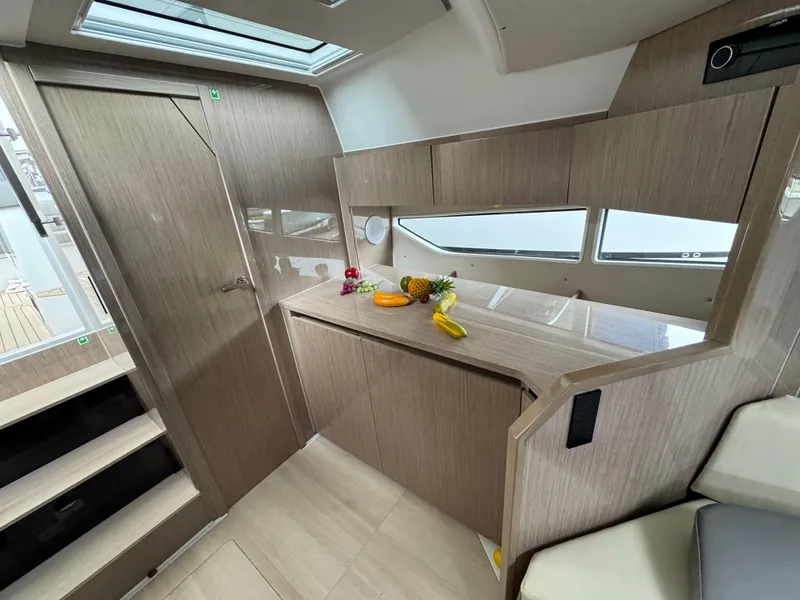 Slide: The Image of 2024 Sealine S335V yacht interior with modern wood finish and skylight. - 21