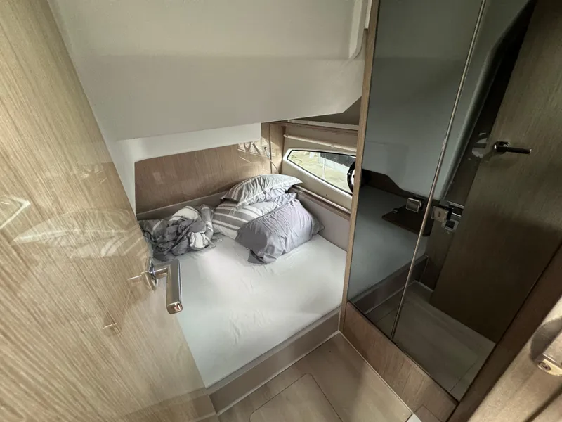 Slide: The Image of 2024 Sealine S335V cabin interior with bed and window view. - 25