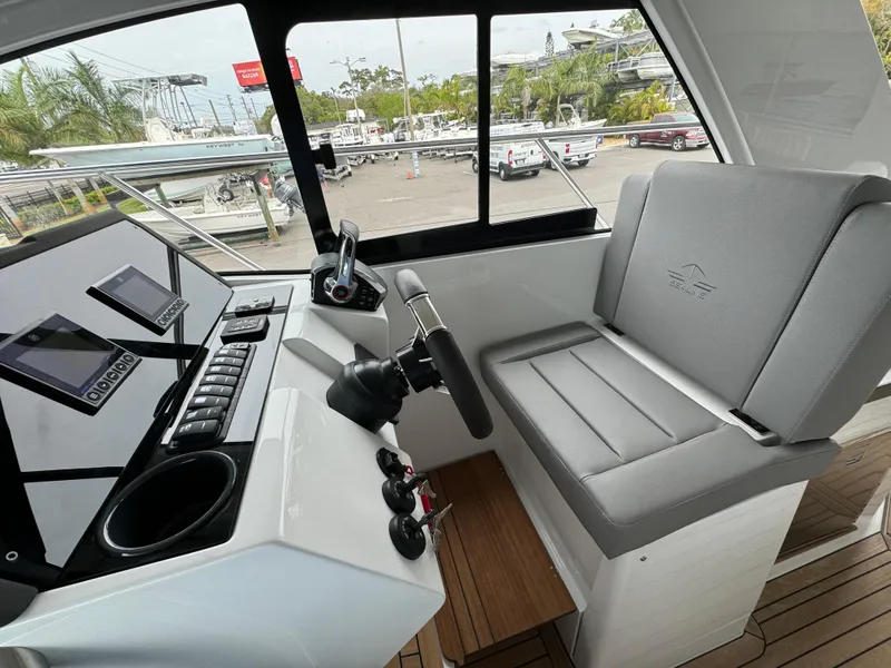 Slide: The Image of 2024 Sealine S335V boat cockpit with modern controls and seating. - 27