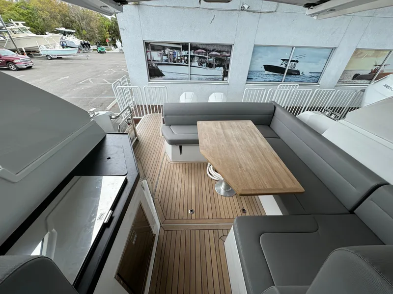 Slide: The Image of 2024 Sealine S335V boat interior with sleek seating and wooden table. - 29