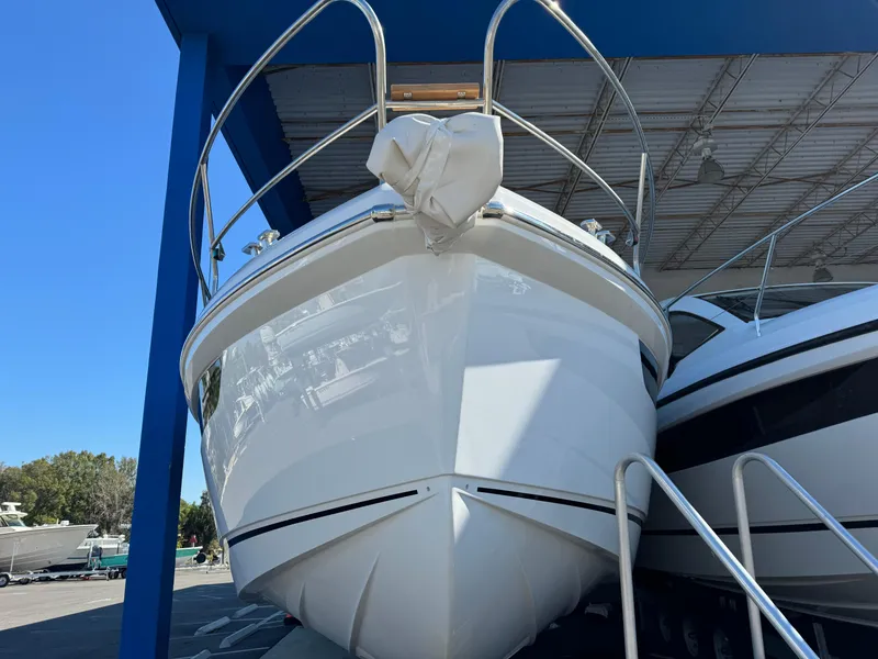 Slide: The Image of 2024 Sealine S335V yacht in a marina, front view under a blue canopy. - 4