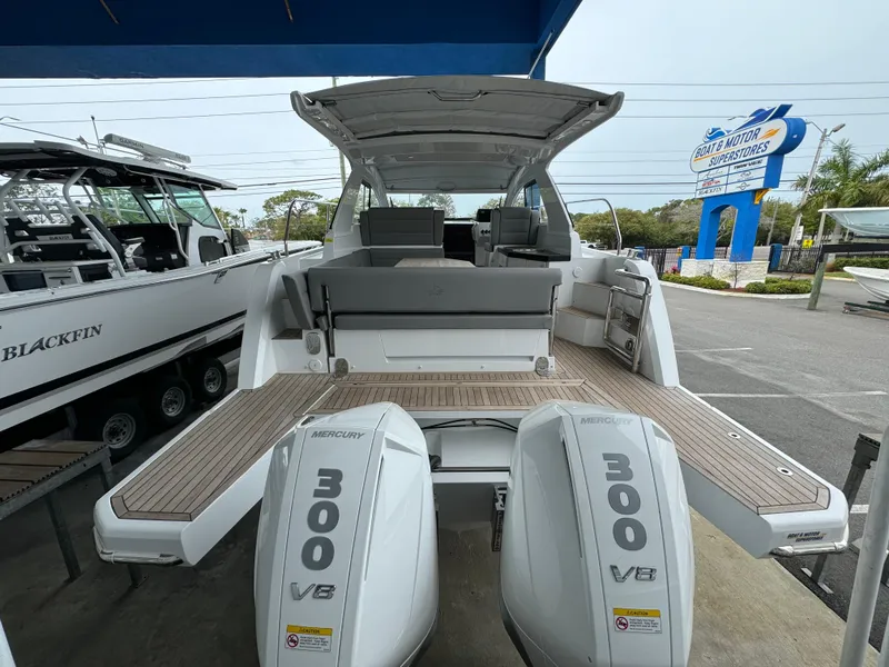 Slide: The Image of 2024 Sealine S335V boat with twin Mercury 300 V8 engines, displayed outdoors. - 5