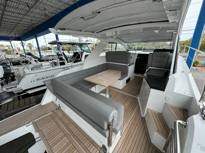 Slide: The Image of 2024 Sealine S335V yacht interior with sleek seating and wooden flooring. - 8