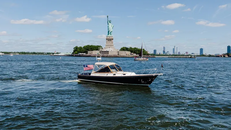 Slide: The Image of Little Harbor WhisperJet 38 boat near Statue of Liberty, 1998 model, sailing in New York Harbor. - 1