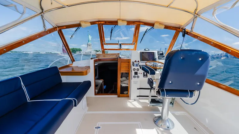 Slide: The Image of Cockpit of 1998 Little Harbor WhisperJet 38 with blue seating and steering wheel. - 14