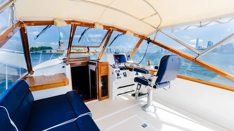 Slide: The Image of Interior view of 1998 Little Harbor WhisperJet 38 yacht with blue seating and wooden accents. - 16