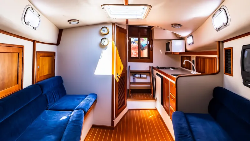 Slide: The Image of Interior of 1998 Little Harbor WhisperJet 38 yacht with blue seating and wooden finishes. - 19