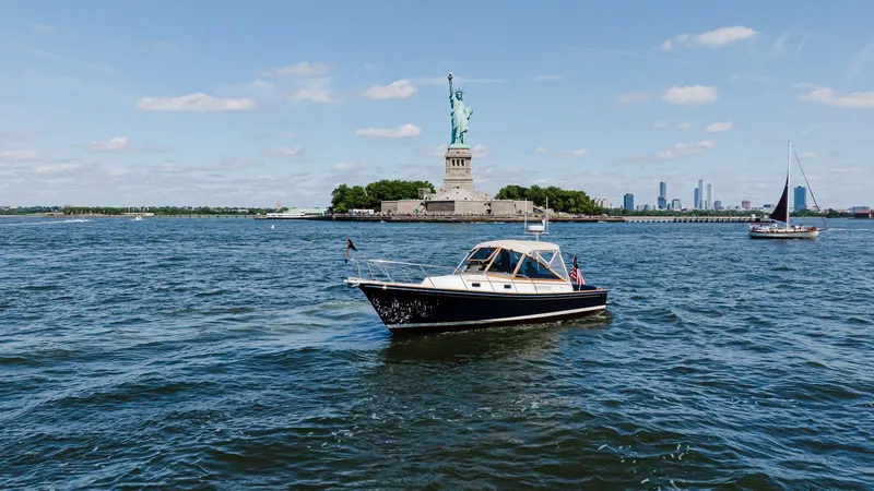 Slide: The Image of Little Harbor WhisperJet 38 boat near Statue of Liberty, 1998 model. - 2