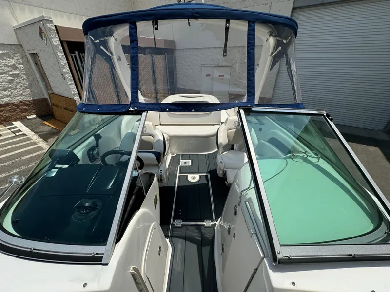 Slide: The Image of 2009 Chaparral SSX 236 boat with open cockpit and windshield, docked outdoors. - 13