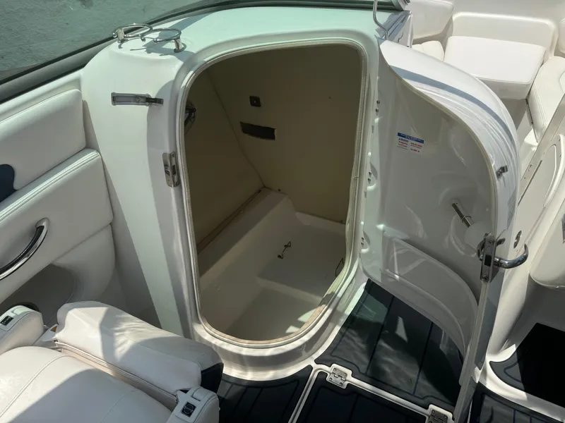 Slide: The Image of 2009 Chaparral SSX 236 boat interior storage compartment with open door. - 15