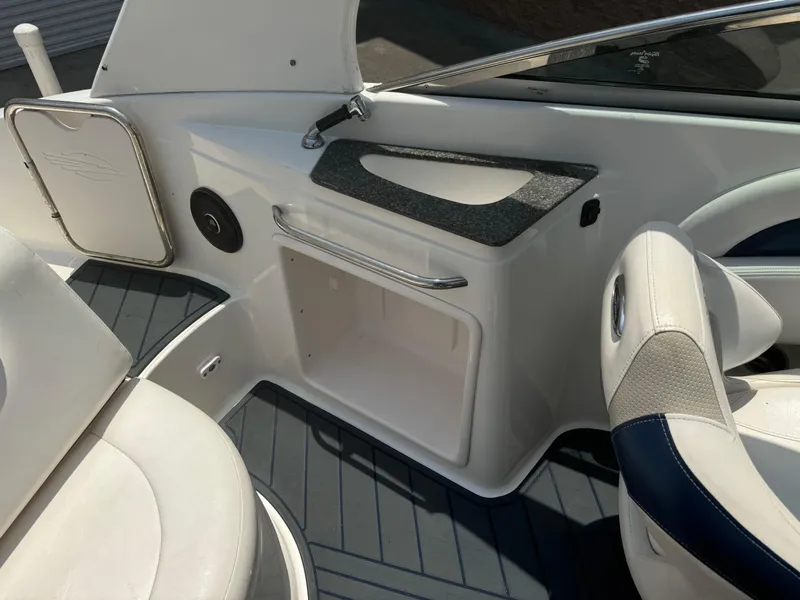 Slide: The Image of 2009 Chaparral SSX 236 boat interior with white seating and storage compartment. - 17