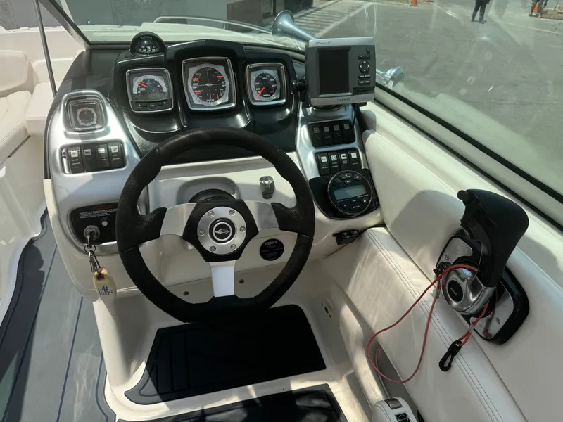 Slide: The Image of 2009 Chaparral SSX 236 boat dashboard with steering wheel and navigation instruments. - 21