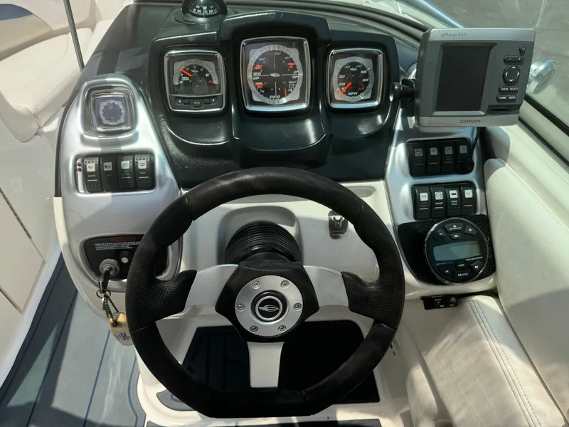 Slide: The Image of 2009 Chaparral SSX 236 boat dashboard with steering wheel and gauges. - 22
