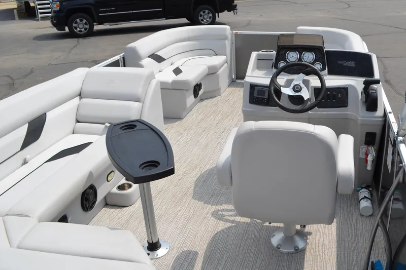 Slide: The Image of 2021 SunCatcher Select Series 20c pontoon boat interior with plush seating and steering console. - 11