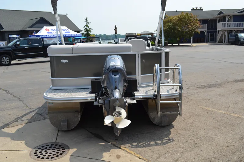 Slide: The Image of 2021 SunCatcher Select Series 20c pontoon boat with outboard motor in a parking lot. - 3