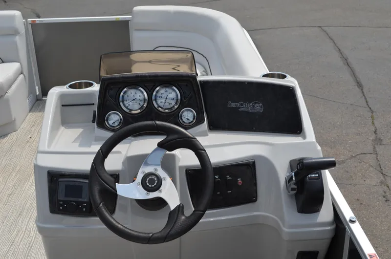 Slide: The Image of 2021 SunCatcher Select Series 20c boat dashboard with steering wheel and gauges. - 5