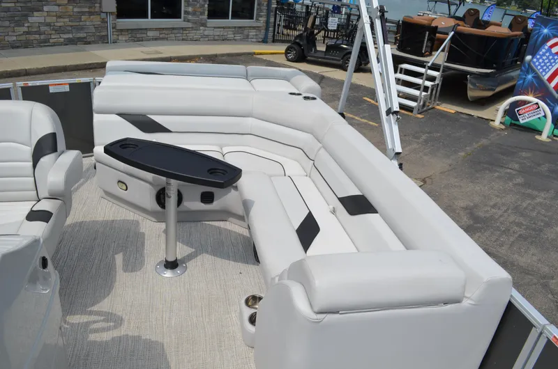 Slide: The Image of 2021 SunCatcher Select Series 20c pontoon boat interior with plush seating and table. - 7
