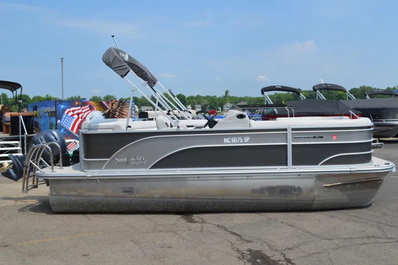 Slide: The Image of 2021 SunCatcher Select Series 20c pontoon boat parked on pavement. - 9