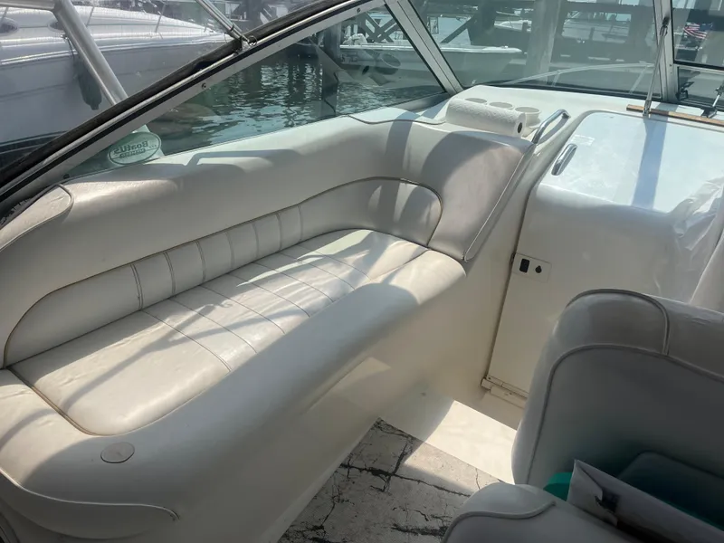 Slide: The Image of Interior of 1998 Sea Ray 27 Sundancer boat with white seating and dashboard. - 11