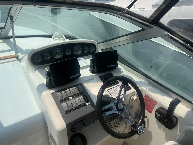 Slide: The Image of 1998 Sea Ray 27 Sundancer helm with steering wheel and navigation instruments. - 3