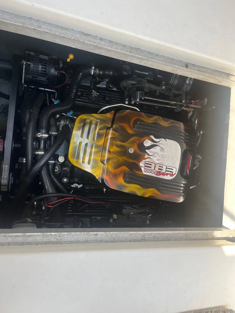 Slide: The Image of 1998 Sea Ray 27 Sundancer engine with custom flame design cover. - 6