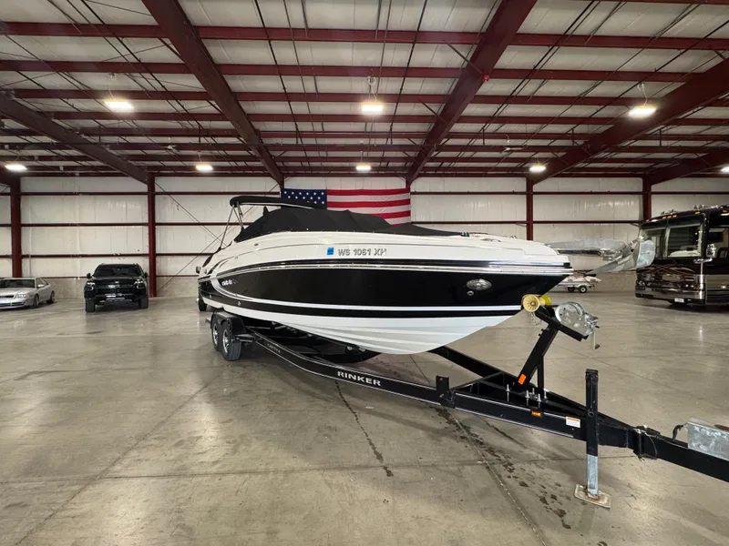 Slide: The Image of 2013 Rinker 276 Captiva Bowrider on trailer in spacious indoor storage. - 10