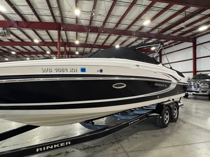 Slide: The Image of 2013 Rinker 276 Captiva Bowrider in indoor storage on trailer. - 12