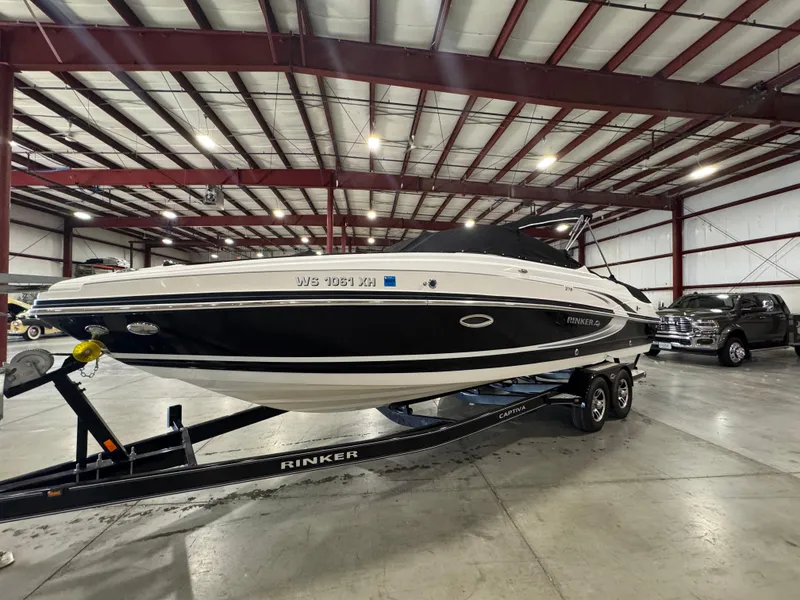 Slide: The Image of 2013 Rinker 276 Captiva Bowrider on trailer in warehouse setting. - 15