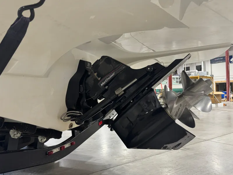 Slide: The Image of 2013 Rinker 276 Captiva Bowrider boat with MerCruiser outdrive in a garage. - 17