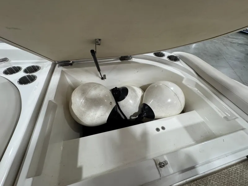 Slide: The Image of Storage compartment of 2013 Rinker 276 Captiva Bowrider with boat fenders inside. - 25