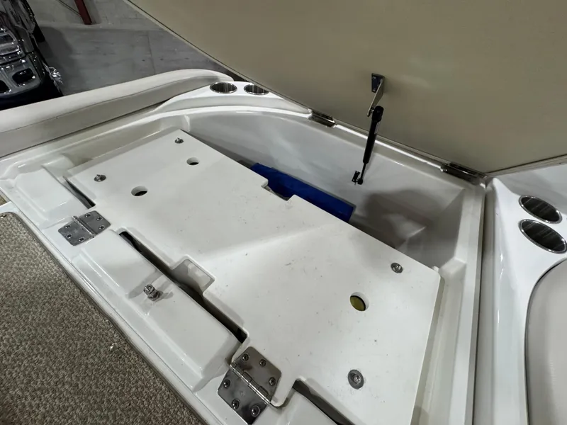 Slide: The Image of Open storage compartment in 2013 Rinker 276 Captiva Bowrider boat. - 27