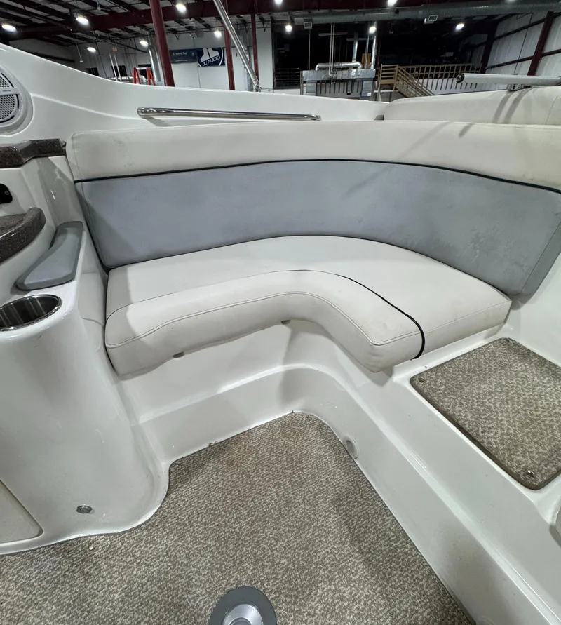Slide: The Image of 2013 Rinker 276 Captiva Bowrider interior seating with gray and white upholstery. - 31