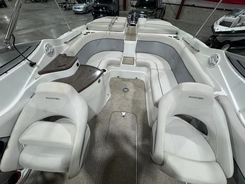 Slide: The Image of 2013 Rinker 276 Captiva Bowrider interior with white seating and carpeted flooring. - 33