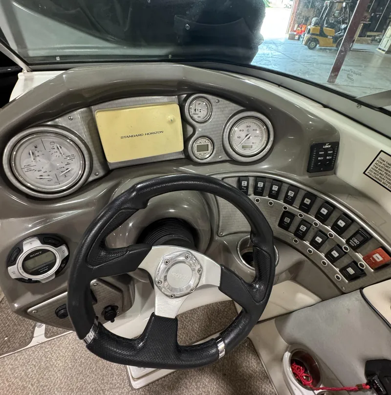 Slide: The Image of 2013 Rinker 276 Captiva Bowrider dashboard with steering wheel and control panel. - 34
