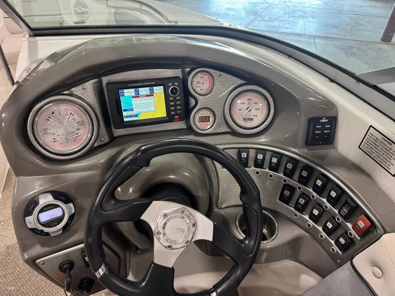 Slide: The Image of 2013 Rinker 276 Captiva Bowrider dashboard with steering wheel and control panel. - 35