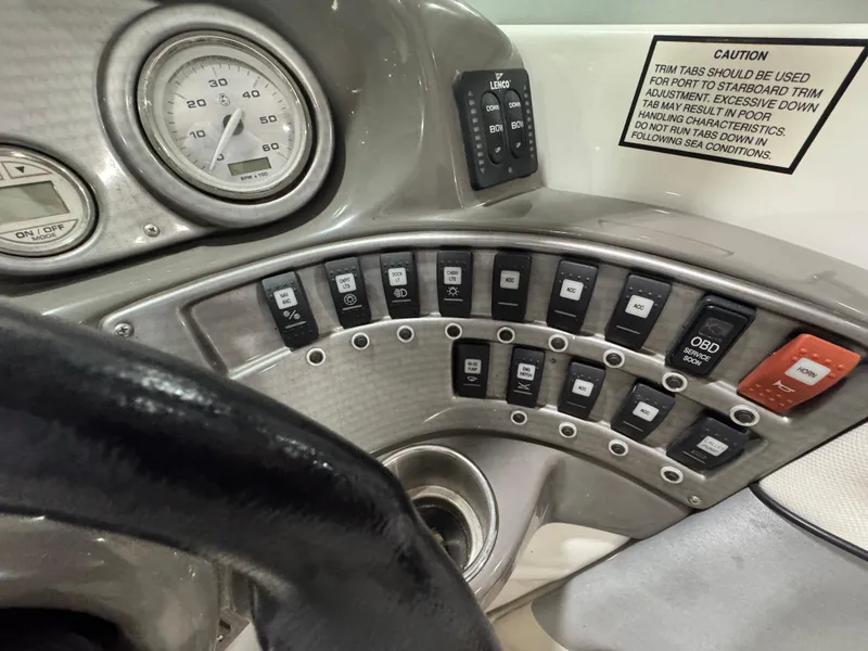 Slide: The Image of 2013 Rinker 276 Captiva Bowrider dashboard with gauges and control switches. - 37