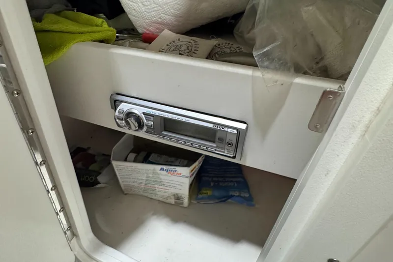 Slide: The Image of Storage compartment in a 2013 Rinker 276 Captiva Bowrider with a stereo system. - 42
