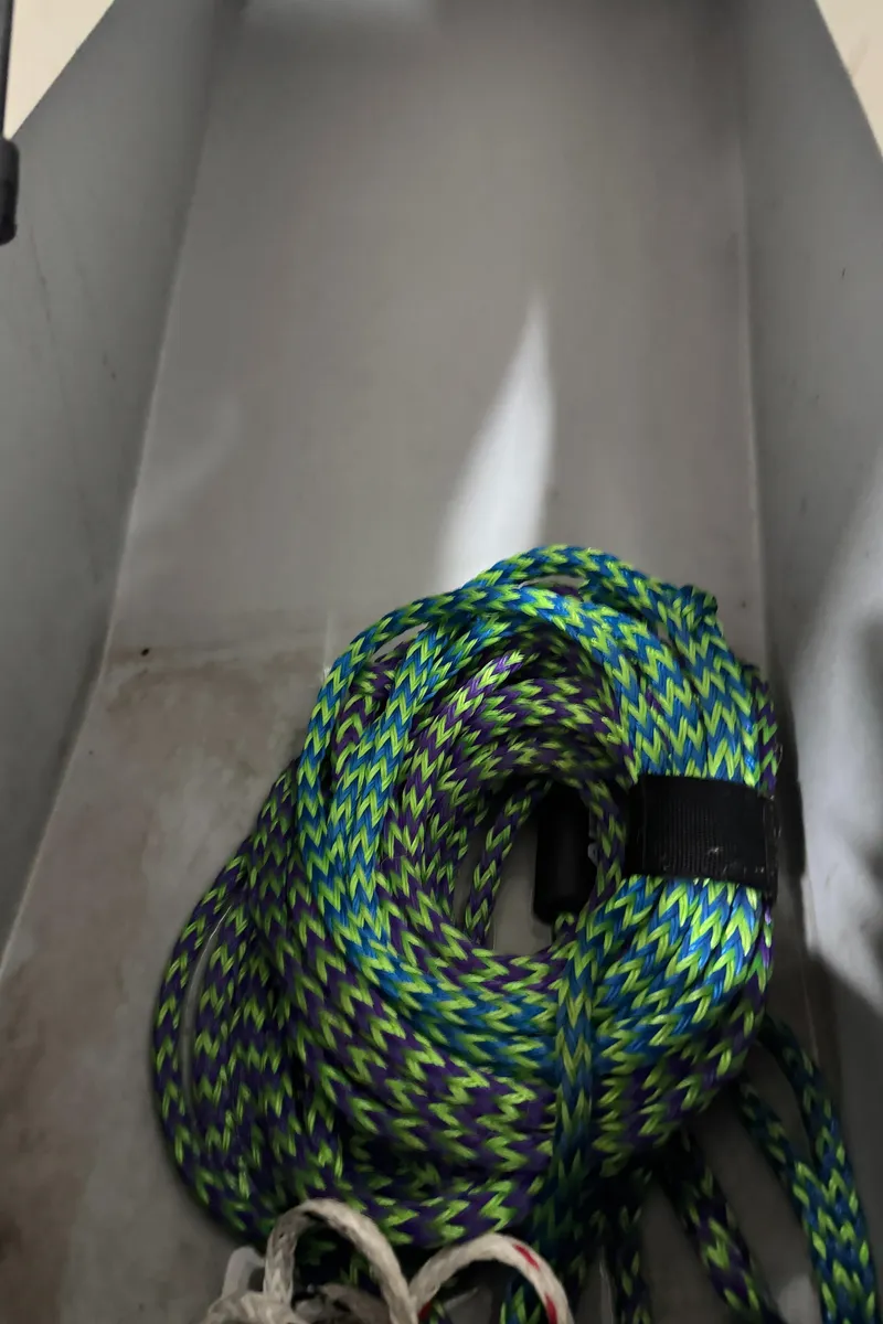 Slide: The Image of Coiled rope in a 2013 Rinker 276 Captiva Bowrider storage compartment. - 44