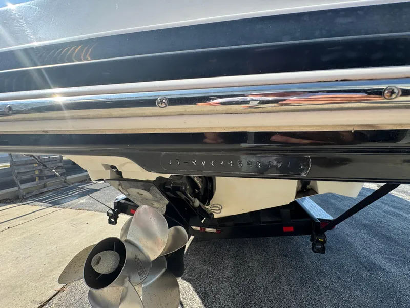 Slide: The Image of 2013 Rinker 276 Captiva Bowrider boat stern with propeller and trailer. - 7