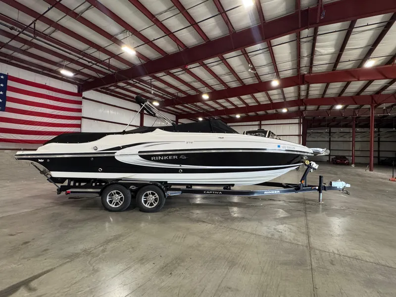 Slide: The Image of 2013 Rinker 276 Captiva Bowrider in a spacious indoor storage facility. - 9