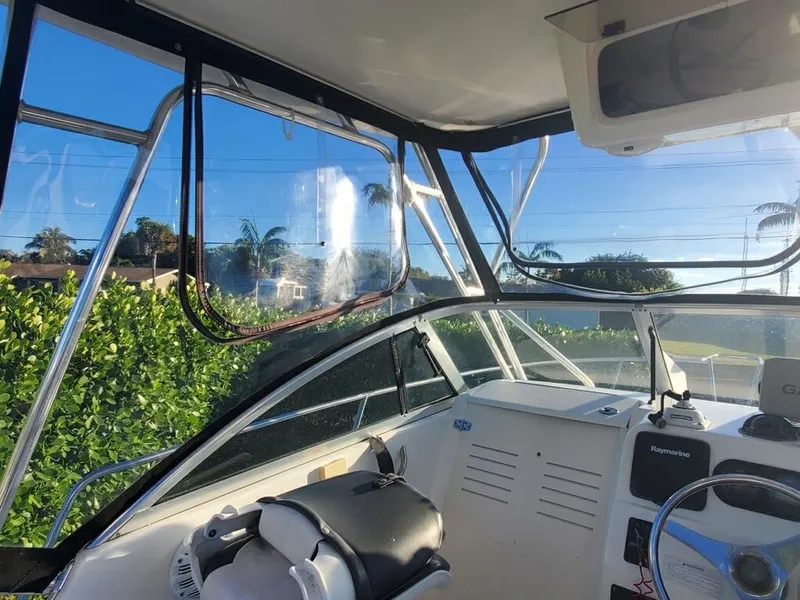 Slide: The Image of Interior view of 2003 Century 24 WALKAROUND boat with clear windows and steering console. - 10