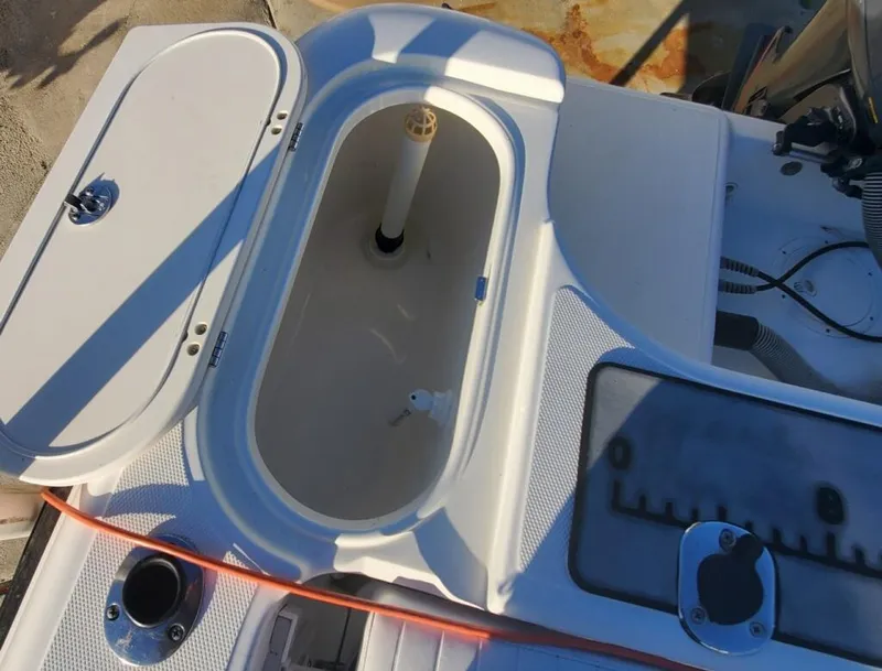 Slide: The Image of 2003 Century 24 Walkaround boat interior with open storage compartment. - 12