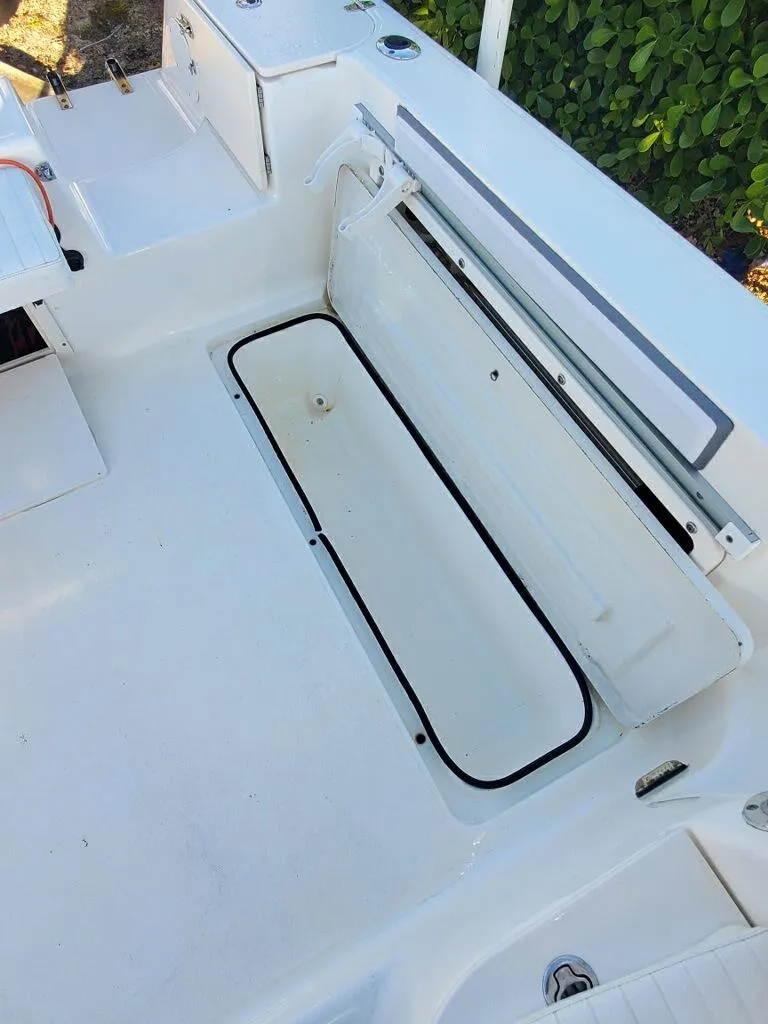 Slide: The Image of 2003 Century 24 WALKAROUND boat interior with open storage compartment. - 14