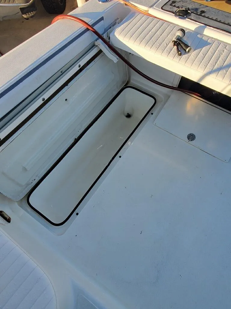 Slide: The Image of 2003 Century 24 Walkaround boat interior with open storage compartment. - 15