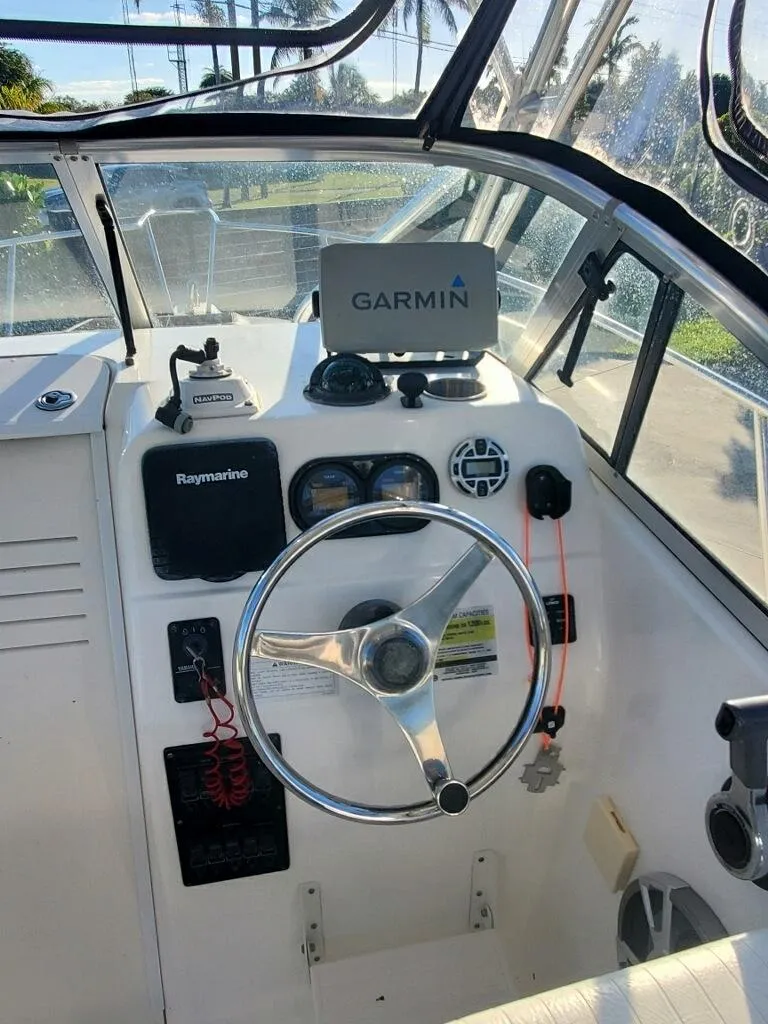 Slide: The Image of 2003 Century 24 Walkaround boat cockpit with Garmin navigation system. - 6