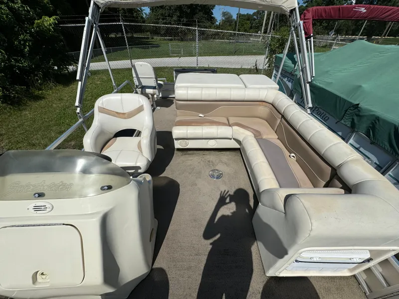 Slide: The Image of Sweetwater 2020DF pontoon boat interior, beige seating, outdoor setting, 2005 model. - 3