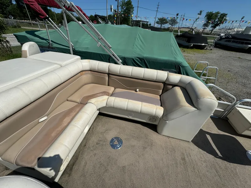 Slide: The Image of Pontoon boat interior with beige seating, Sweetwater 2020DF model, 2005, parked outdoors. - 6